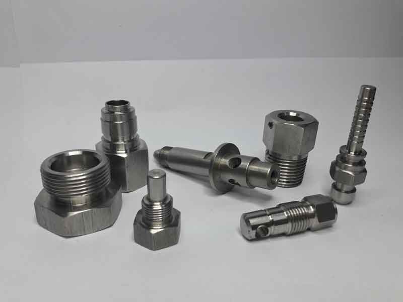 Assortment of stainless fittings, valves, and threaded adapters