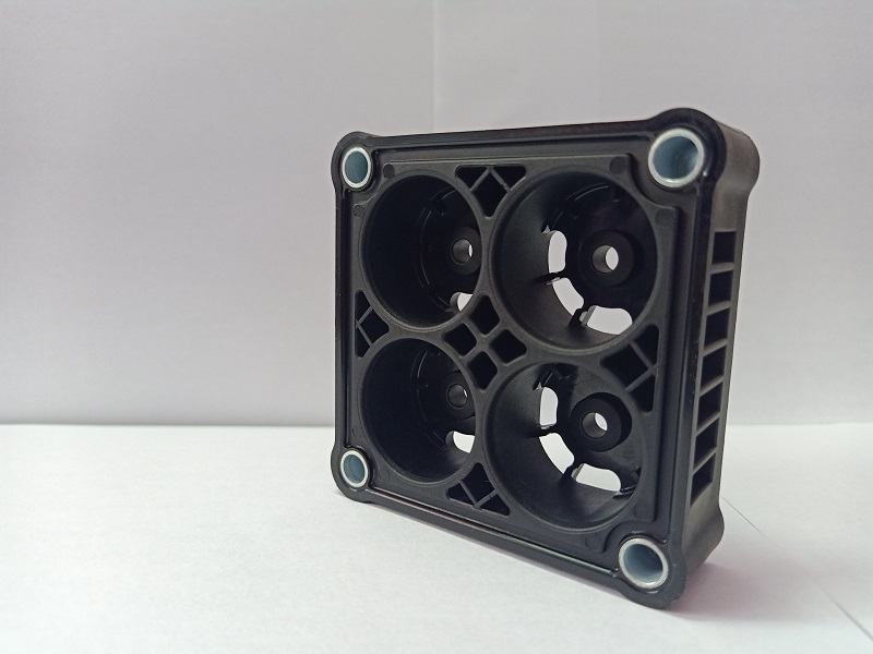 Black plastic housing with metal insert bushings