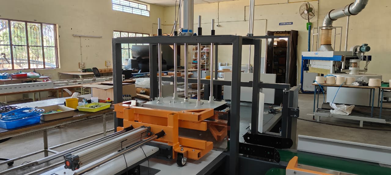 Flow-wrap conveyor section with transfer hardware and guarding